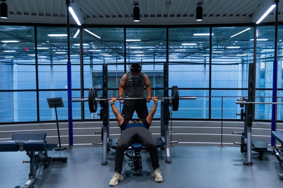 Two students lifting on the fitness floor of the Powerhouse.